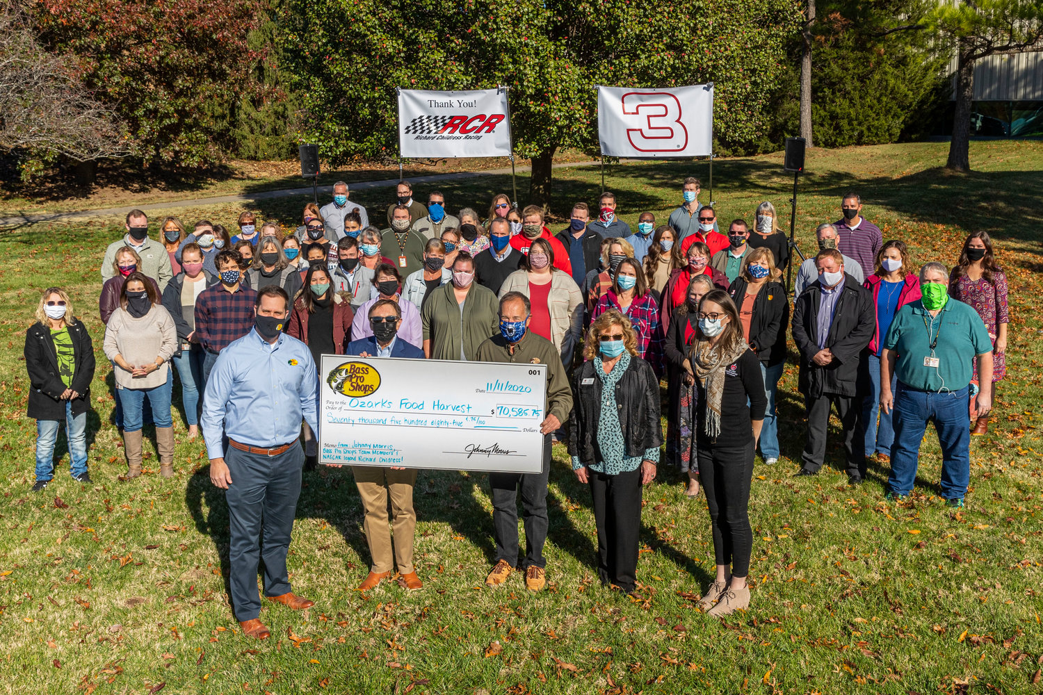Ozarks Food Harvest representatives receive a $70,500 check from Bass Pro Shops founder and CEO Johnny Morris and Bass Pro team members.